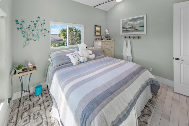 bedroom with light hardwood / wood-style floors and vaulted ceiling