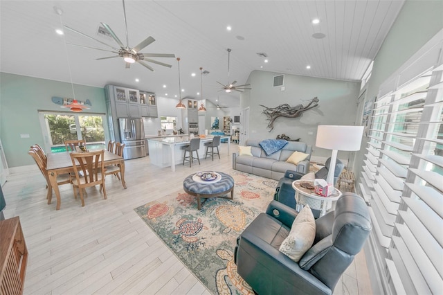 living room featuring ceiling fan, high vaulted ceiling, wood ceiling, and light wood-type flooring