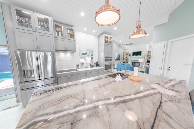 kitchen with decorative light fixtures, light stone countertops, appliances with stainless steel finishes, and wooden ceiling