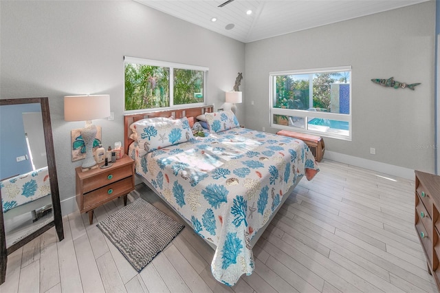 bedroom with light wood-type flooring, lofted ceiling, and wood ceiling