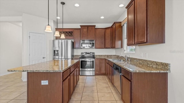 kitchen with stainless steel appliances, sink, pendant lighting, a center island, and light tile patterned flooring