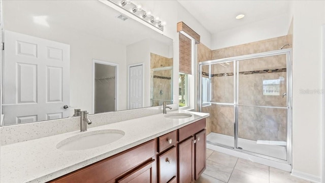 bathroom featuring tile patterned flooring, vanity, and an enclosed shower