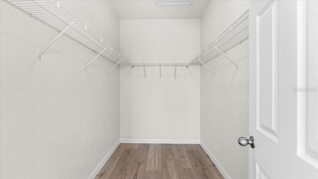 walk in closet featuring hardwood / wood-style floors