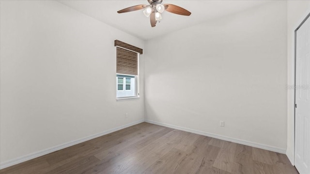 spare room with ceiling fan and light wood-type flooring