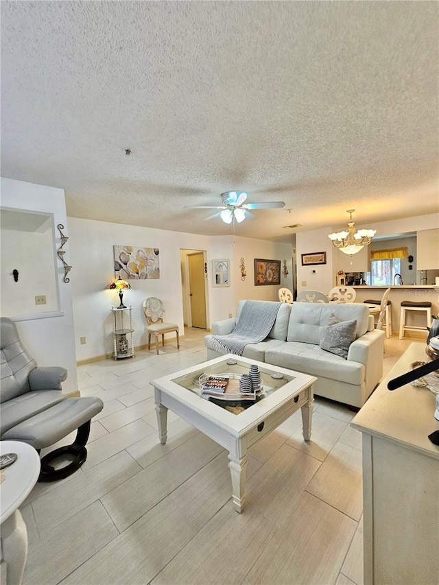 living room featuring ceiling fan with notable chandelier