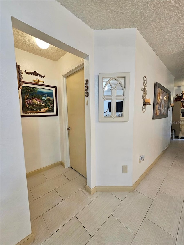 corridor featuring a textured ceiling