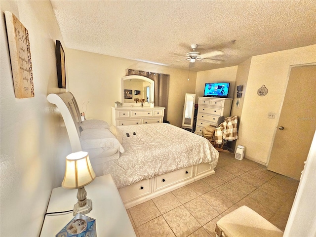 bedroom with ceiling fan and a textured ceiling