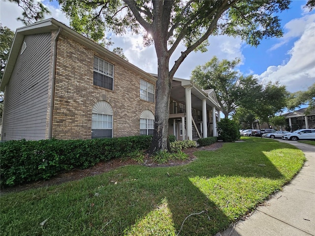 view of side of home featuring a lawn