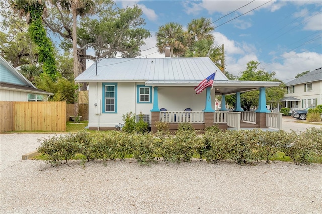 back of property featuring covered porch