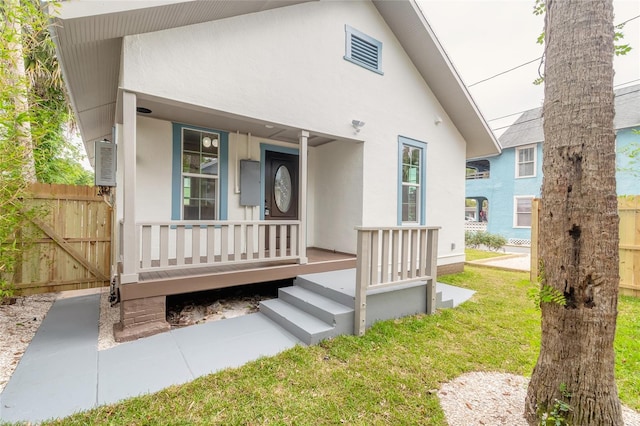 exterior space featuring a lawn and covered porch