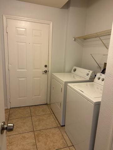 washroom featuring light tile patterned floors and washer and dryer