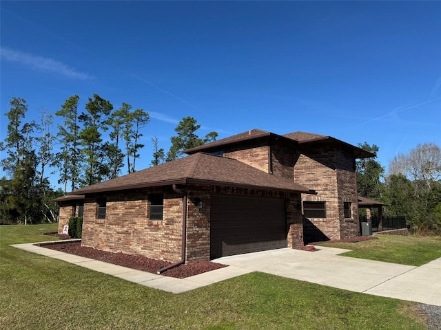 view of side of property featuring brick siding, a garage, a lawn, and driveway