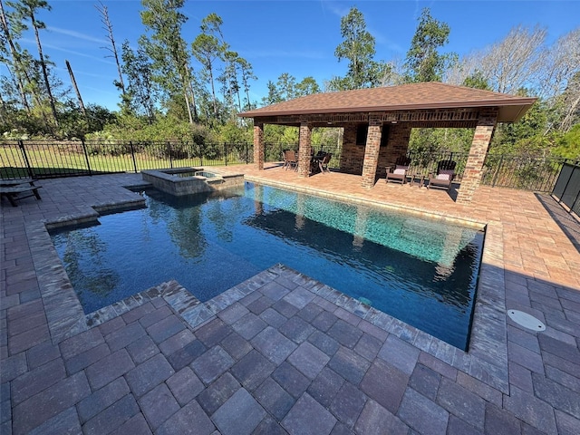 view of pool with an in ground hot tub and a patio