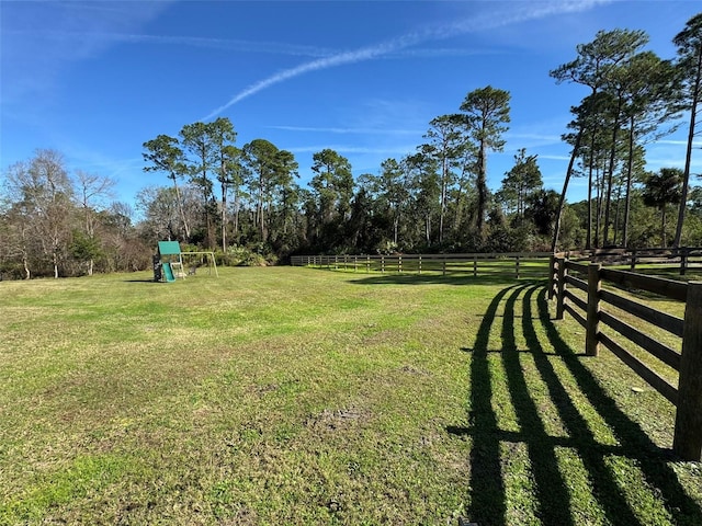 view of yard featuring a playground and fence