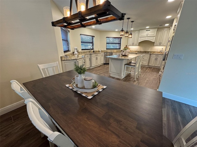 dining area featuring recessed lighting, baseboards, and wood finished floors