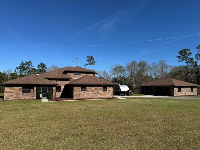 view of property exterior featuring a yard, brick siding, and a shingled roof