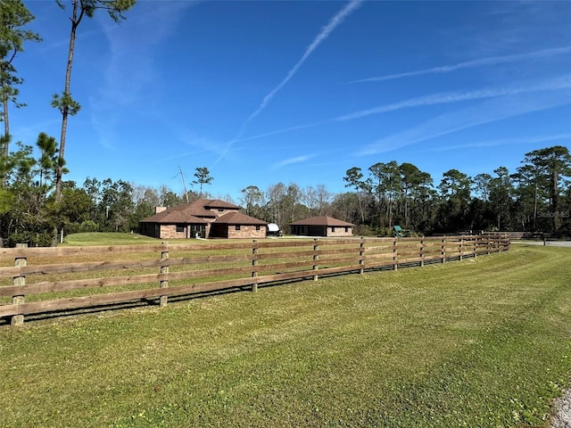 view of yard with a rural view and fence