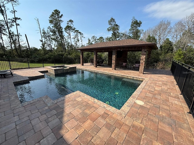 view of swimming pool featuring a gazebo, a fenced backyard, a pool with connected hot tub, and a patio