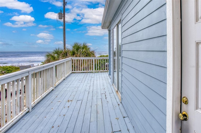 deck with a water view and a view of the beach