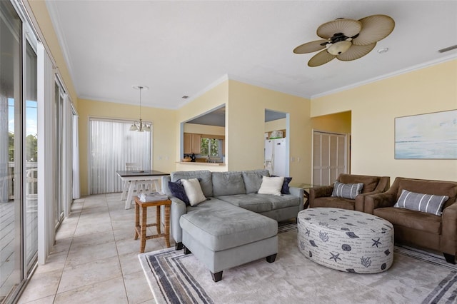 living room with ceiling fan with notable chandelier, light tile patterned floors, and ornamental molding