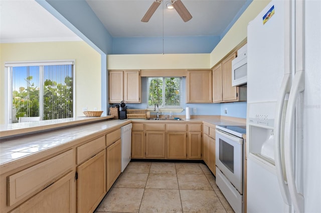 kitchen with light brown cabinets, white appliances, sink, ceiling fan, and light tile patterned flooring