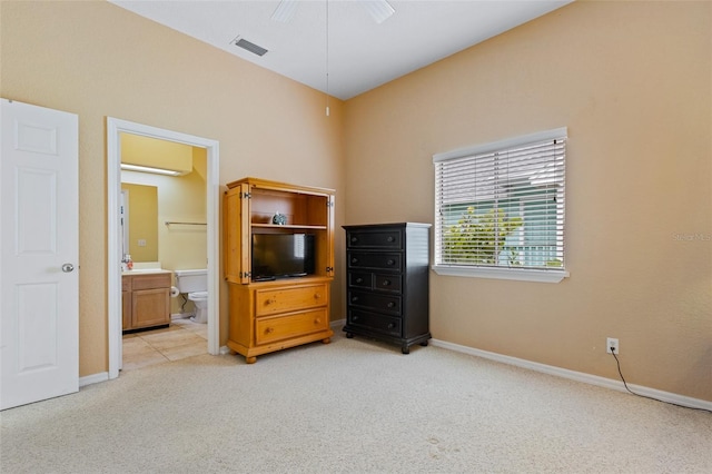 unfurnished bedroom featuring ensuite bathroom and light colored carpet