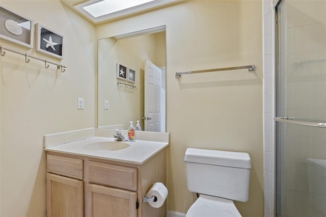 bathroom with vanity, an enclosed shower, and toilet