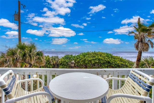 balcony featuring a water view and a beach view