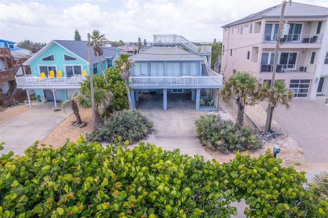 exterior space featuring a balcony and a carport