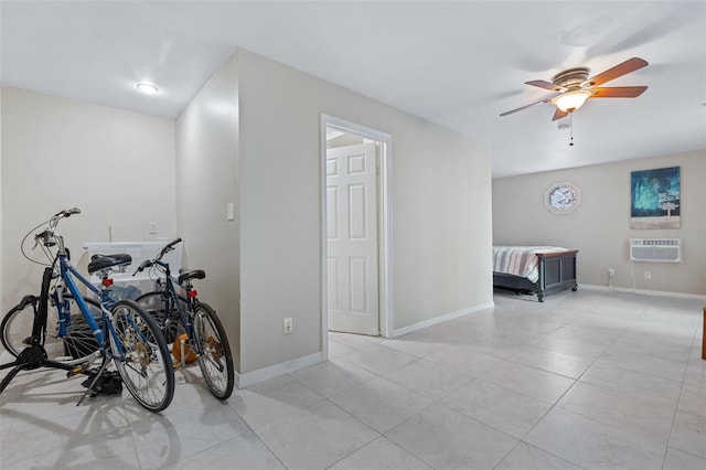 interior space with a wall unit AC and light tile patterned floors