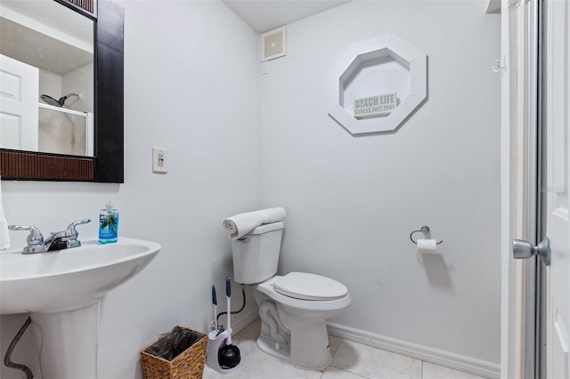 bathroom with tile patterned floors, toilet, and sink