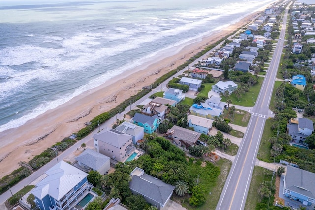 drone / aerial view featuring a view of the beach and a water view