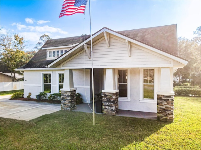 rear view of property with a porch and a yard