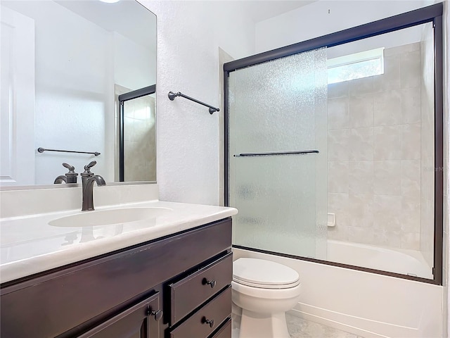 full bathroom with shower / bath combination with glass door, vanity, and toilet