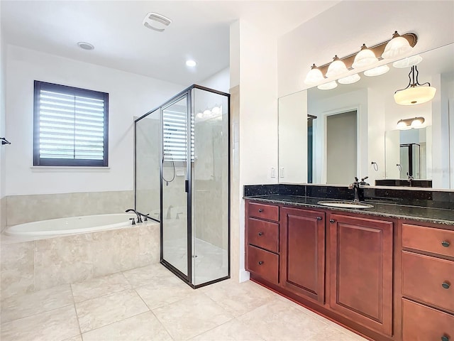 bathroom with tile patterned flooring, vanity, and independent shower and bath