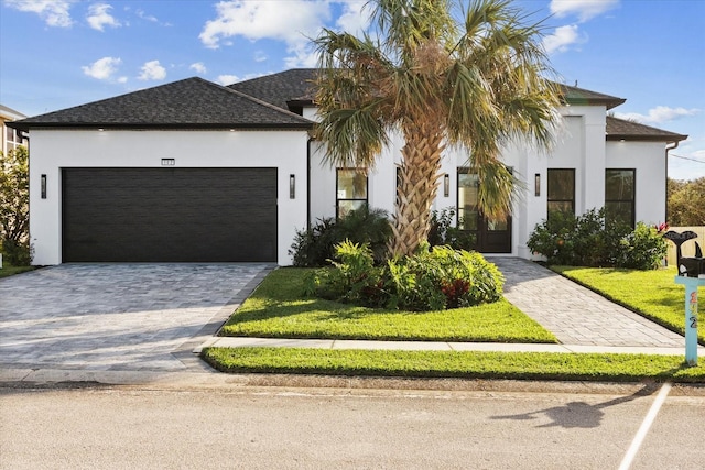 view of front of property with a front lawn and a garage