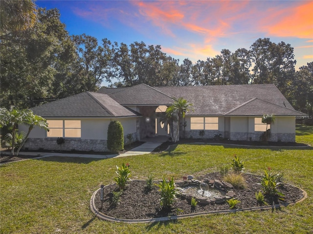 ranch-style house featuring a lawn