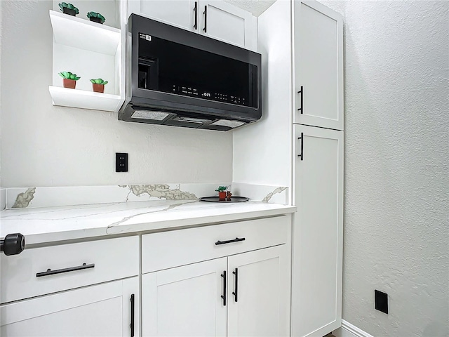 kitchen with white cabinets and light stone countertops