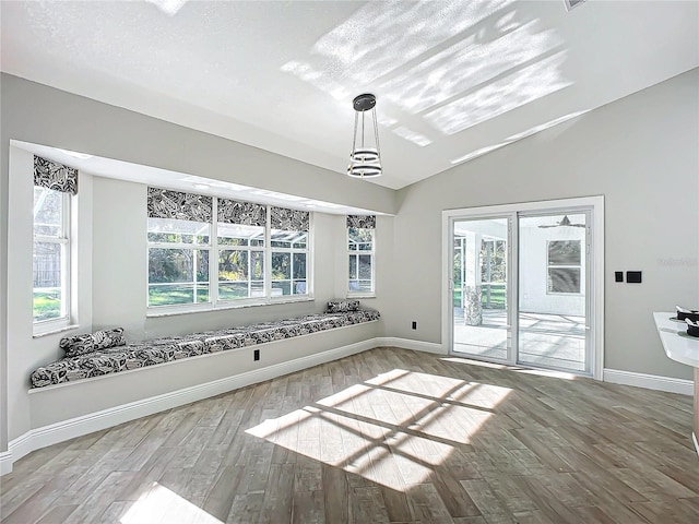 interior space with vaulted ceiling, hardwood / wood-style floors, and a wealth of natural light