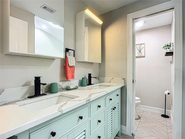 bathroom with vanity and toilet