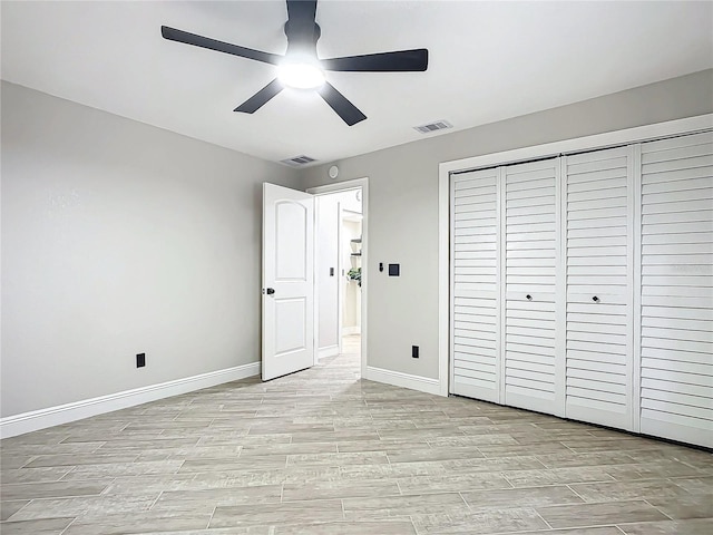 unfurnished bedroom featuring ceiling fan and a closet