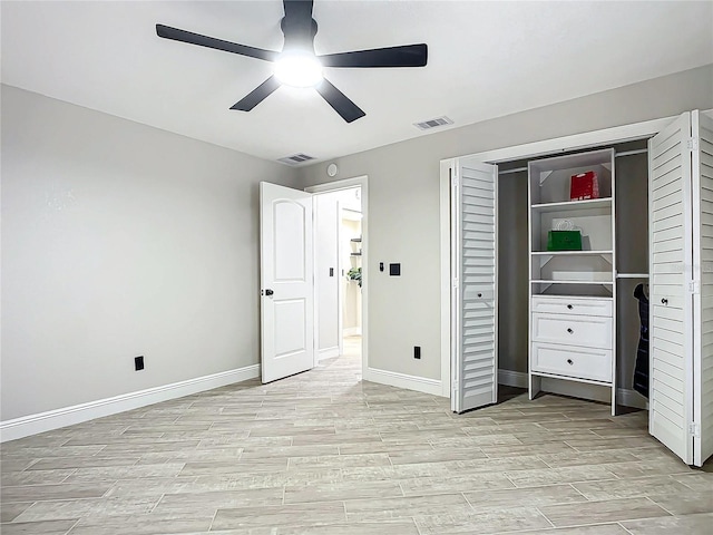 unfurnished bedroom with ceiling fan and a closet