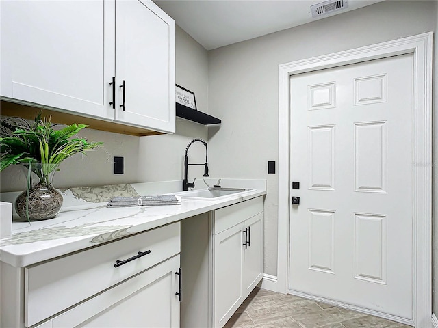 clothes washing area with sink