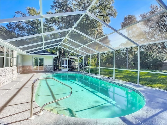 view of pool with a lanai and a patio