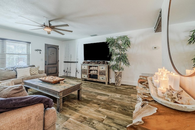 living room with wood-type flooring, a textured ceiling, and ceiling fan