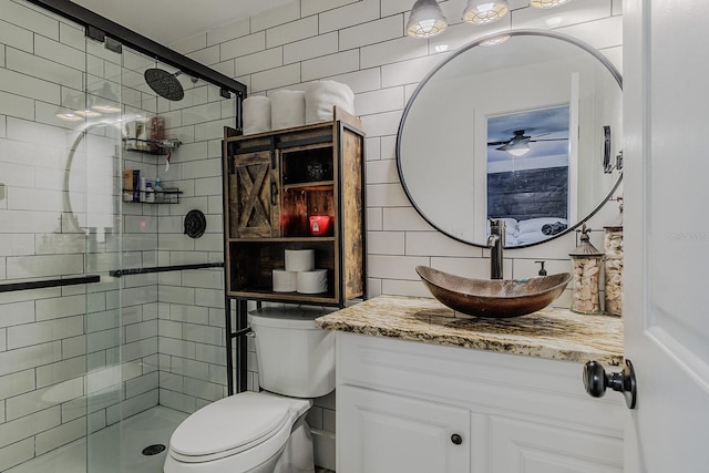 bathroom featuring vanity, toilet, and a shower with door