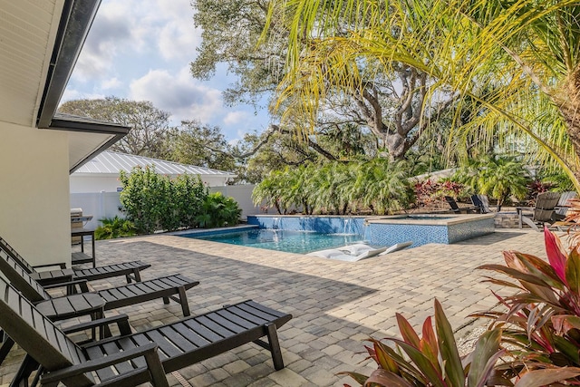 view of swimming pool with an in ground hot tub and a patio area