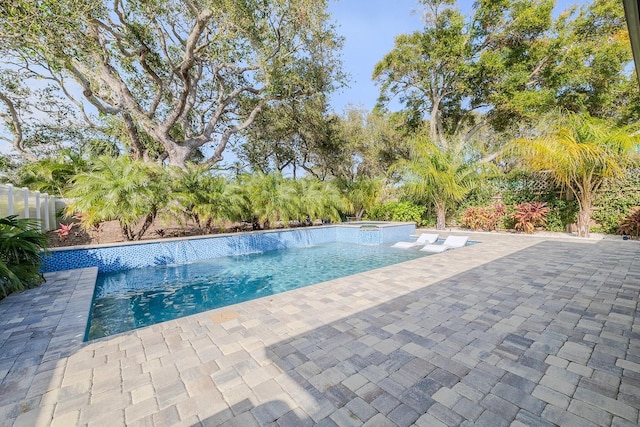 view of swimming pool with an in ground hot tub, a patio, and pool water feature