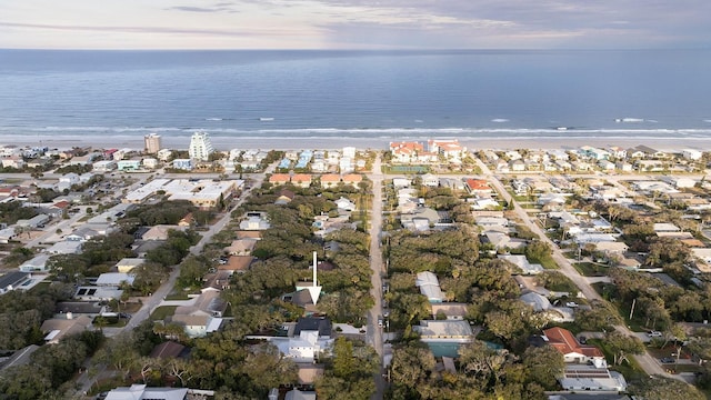 aerial view at dusk featuring a water view