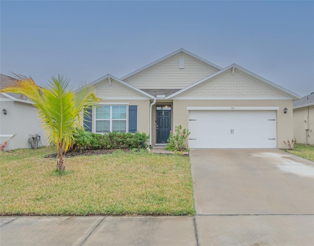 ranch-style house featuring a garage and a front yard